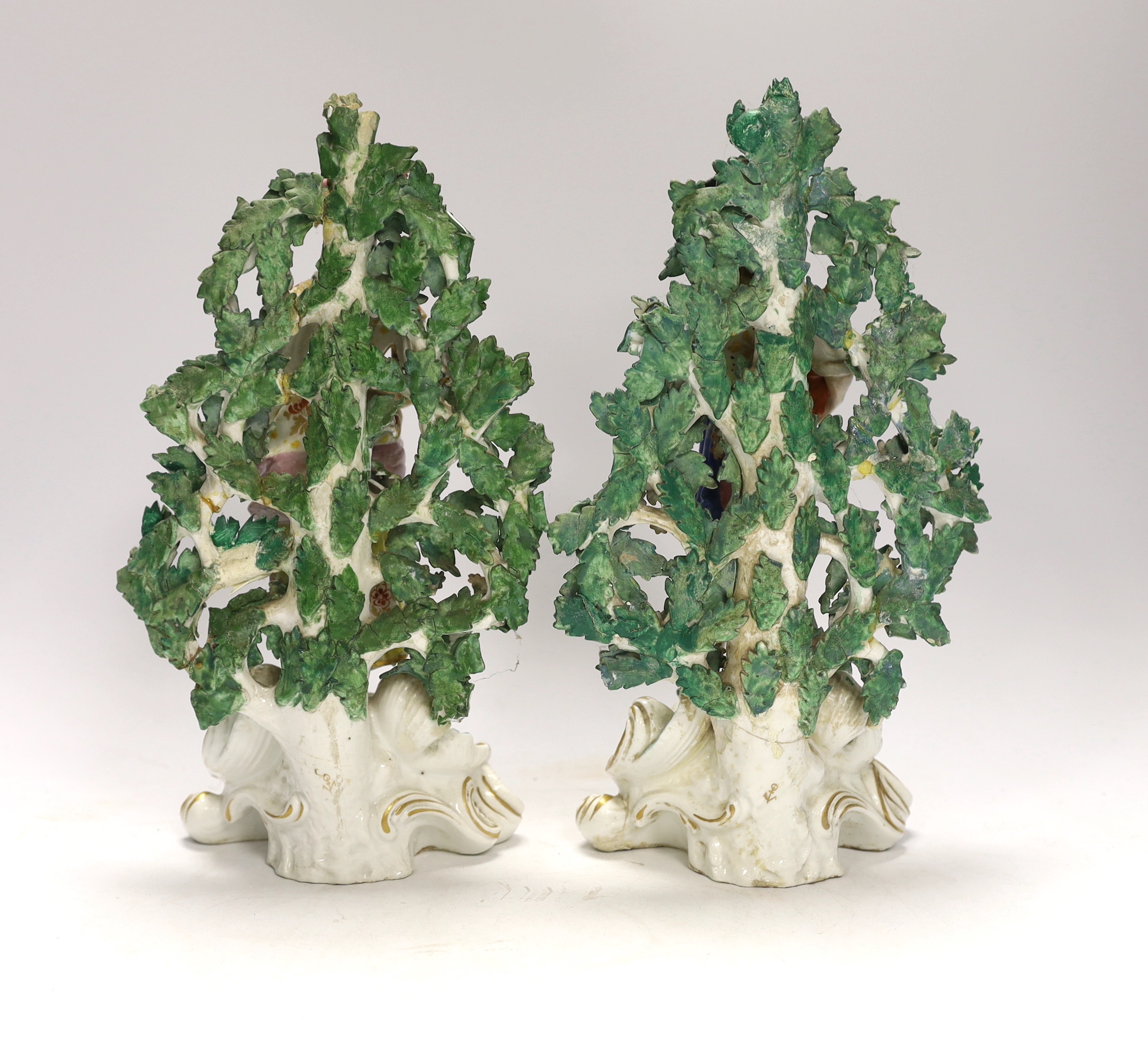 A pair of Continental porcelain figures of gardeners, pseudo Chelsea marks, 28cm high